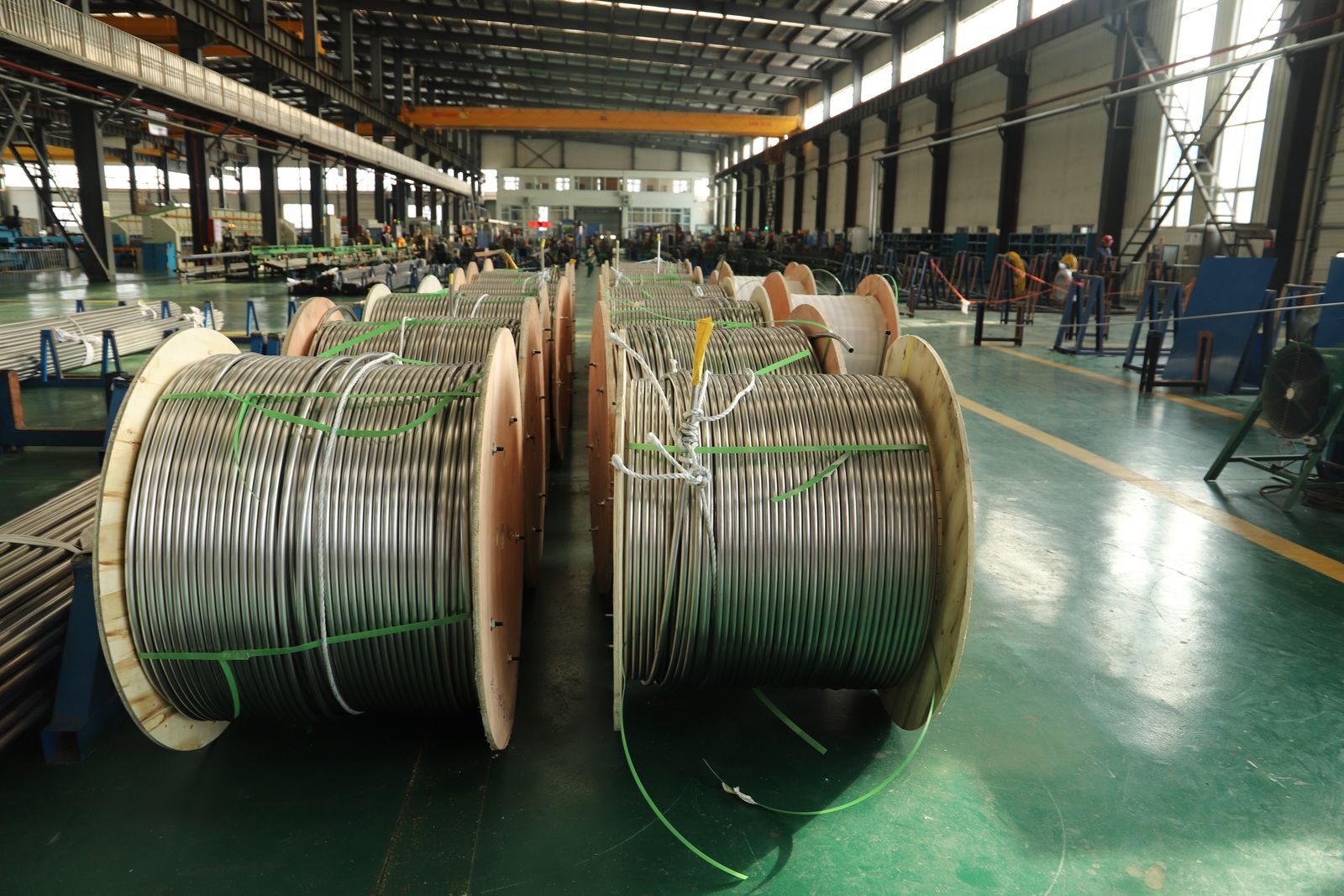 Large industrial cable reels inside a manufacturing facility